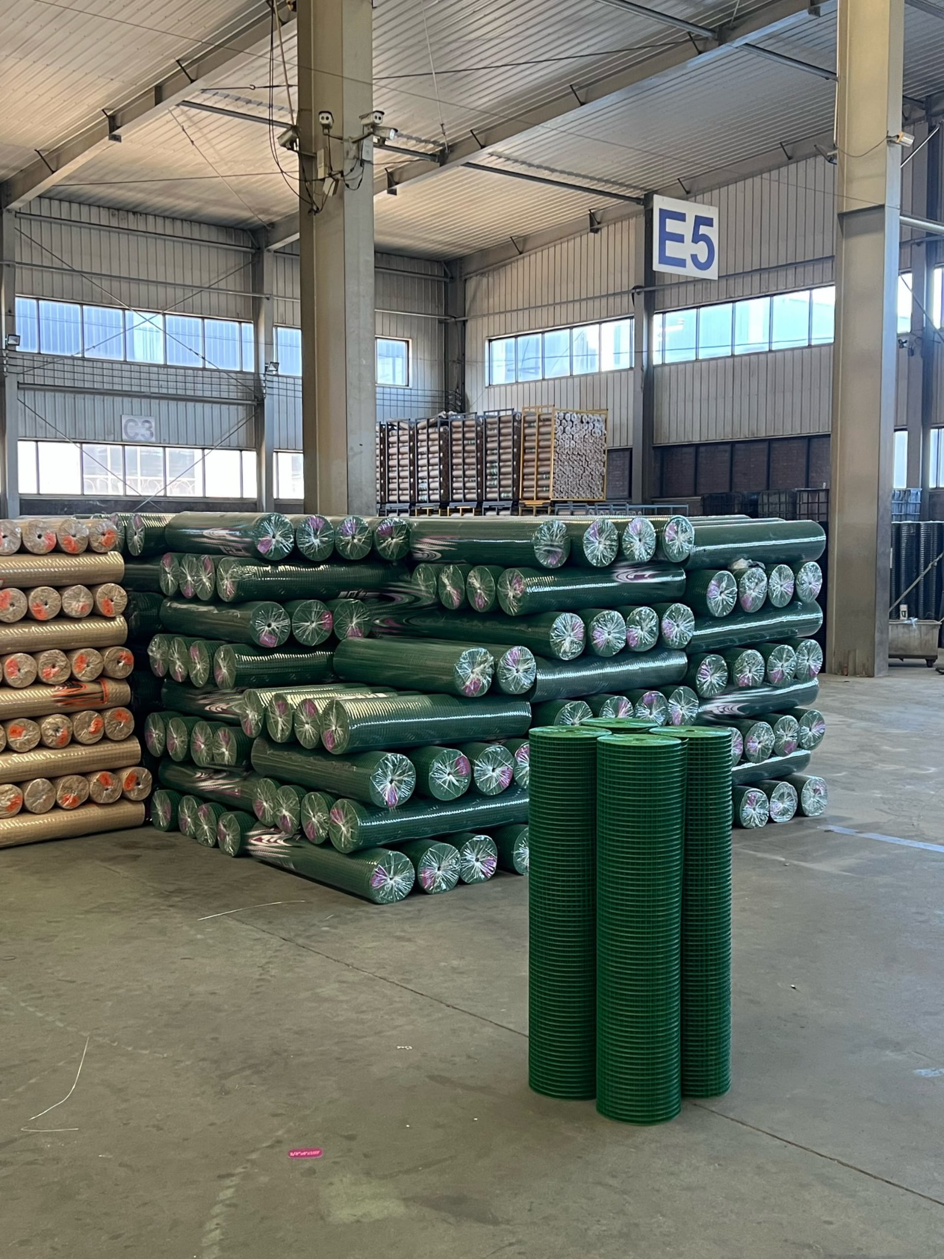 PVC coated welded wire mesh rolls in factory warehouse